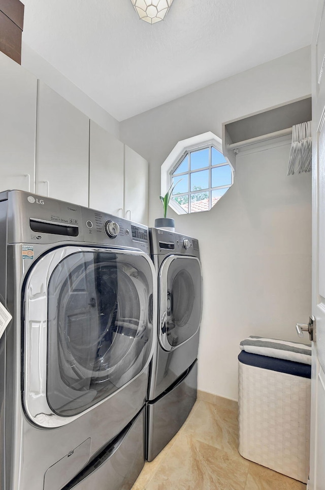 17352 Antigua Point Way, Boca Raton, FL 33487 - laundry room featuring cabinet space, light tile patterned flooring, and washing machine and clothes dryer