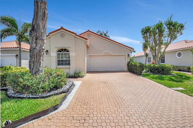 17352 Antigua Point Way, Boca Raton, FL 33487 - mediterranean / spanish-style home with a garage, stucco siding, and decorative driveway