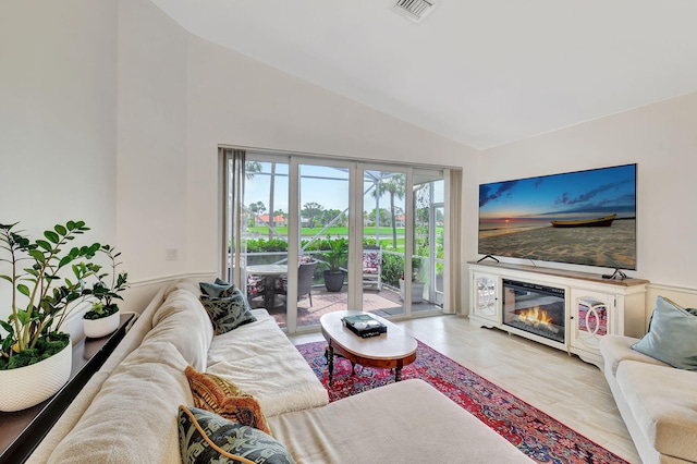 17352 Antigua Point Way, Boca Raton, FL 33487 - living room with high vaulted ceiling, visible vents, and a glass covered fireplace