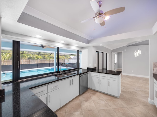 kitchen featuring vaulted ceiling, stainless steel dishwasher, ceiling fan, and a sink