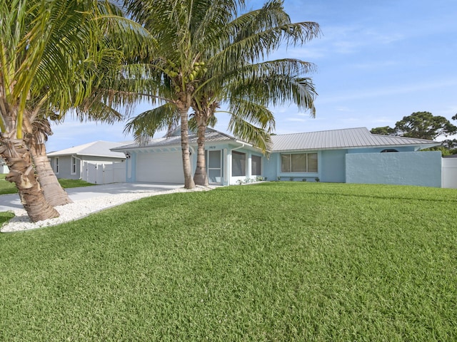 single story home with a front lawn, stucco siding, concrete driveway, an attached garage, and fence