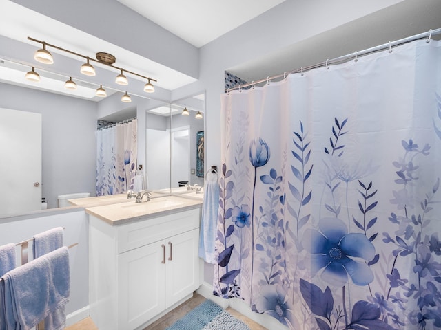 full bath with toilet and vanity