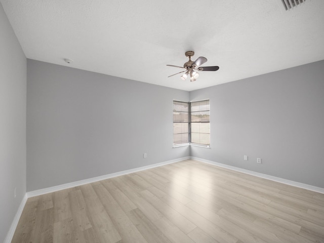 unfurnished room with baseboards, ceiling fan, and light wood-style floors