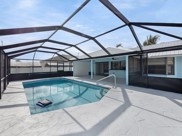 view of pool with a fenced in pool, ceiling fan, glass enclosure, and a patio area