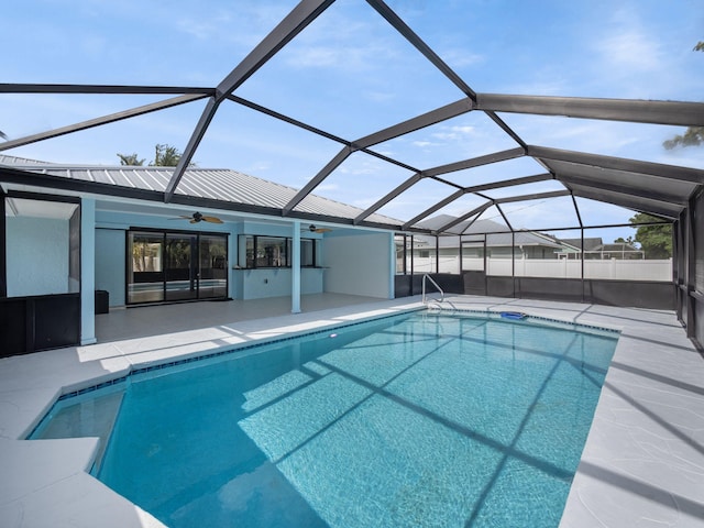 pool featuring a lanai, a ceiling fan, and a patio area