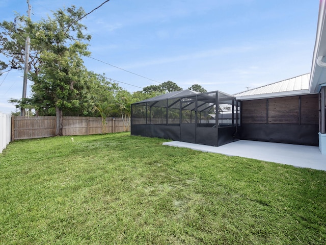 view of yard with a patio, a lanai, and a fenced backyard