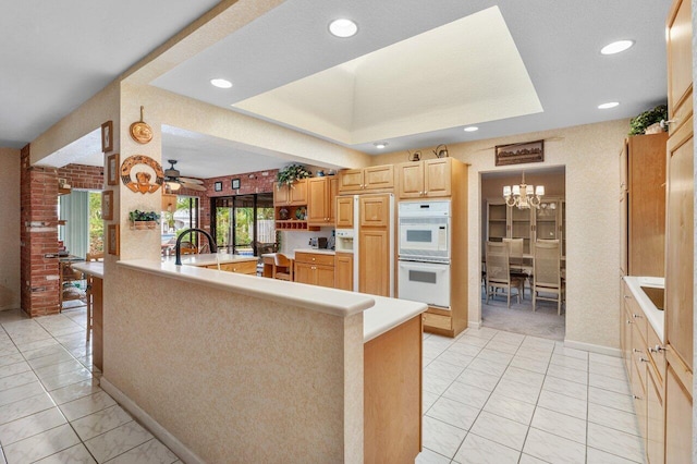 3163 NE 8th Ave, Boca Raton, FL 33431 - kitchen with double oven, light brown cabinets, a chandelier, light countertops, and ceiling fan