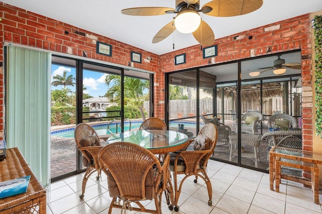 3163 NE 8th Ave, Boca Raton, FL 33431 - sunroom / solarium featuring tile patterned flooring, brick wall, and healthy amount of natural light