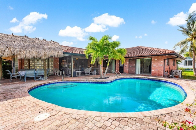 3163 NE 8th Ave, Boca Raton, FL 33431 - swimming pool featuring a patio area and a sunroom