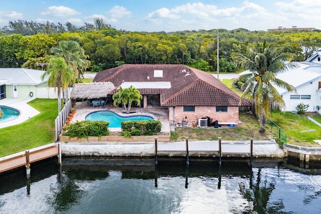 3163 NE 8th Ave, Boca Raton, FL 33431 - back of house featuring a tile roof, an outdoor pool, central air condition unit, and a patio