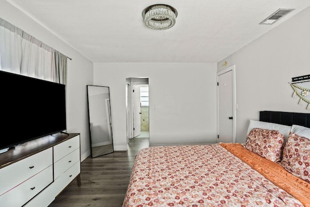 bedroom featuring dark wood-style floors, visible vents, and baseboards