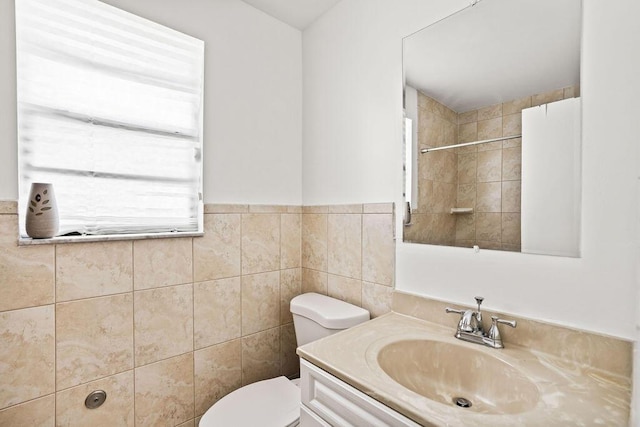 full bathroom featuring toilet, tile walls, walk in shower, and vanity