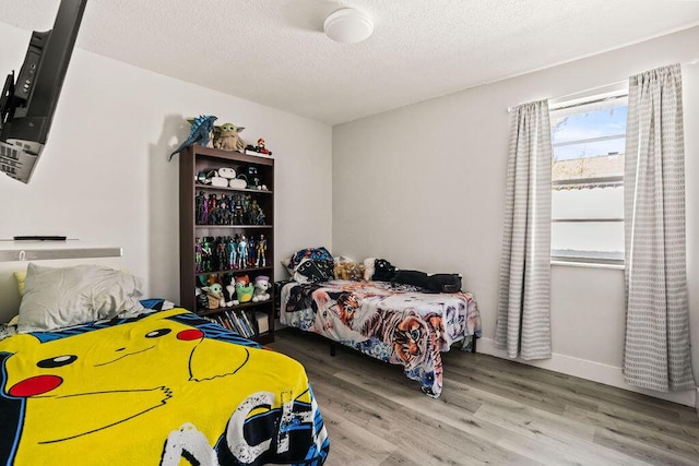 bedroom featuring a textured ceiling and wood finished floors