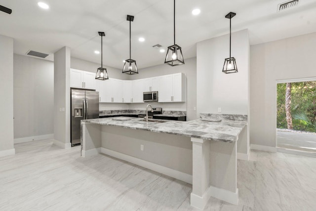 899 Gladiola Ave, Sebastian, FL 32958 - kitchen featuring baseboards, appliances with stainless steel finishes, visible vents, and light stone countertops