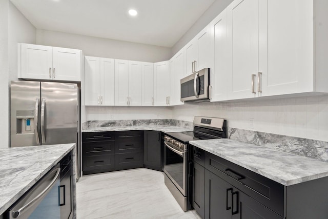 899 Gladiola Ave, Sebastian, FL 32958 - kitchen featuring white cabinets, light stone countertops, and stainless steel appliances