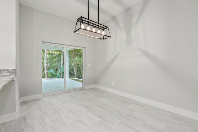 899 Gladiola Ave, Sebastian, FL 32958 - unfurnished dining area with baseboards and a chandelier