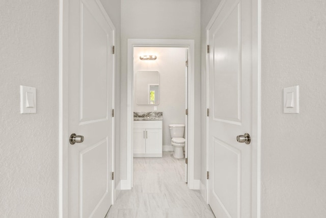 899 Gladiola Ave, Sebastian, FL 32958 - hallway featuring baseboards and marble finish floor
