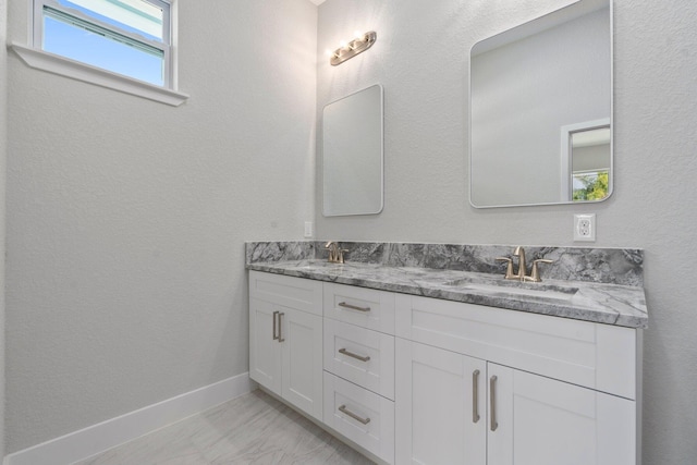 899 Gladiola Ave, Sebastian, FL 32958 - bathroom featuring a sink, baseboards, double vanity, and marble finish floor
