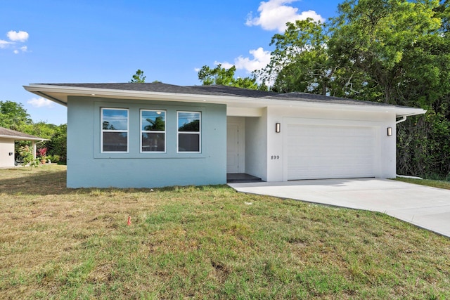 899 Gladiola Ave, Sebastian, FL 32958 - ranch-style home with concrete driveway, an attached garage, a front lawn, and stucco siding