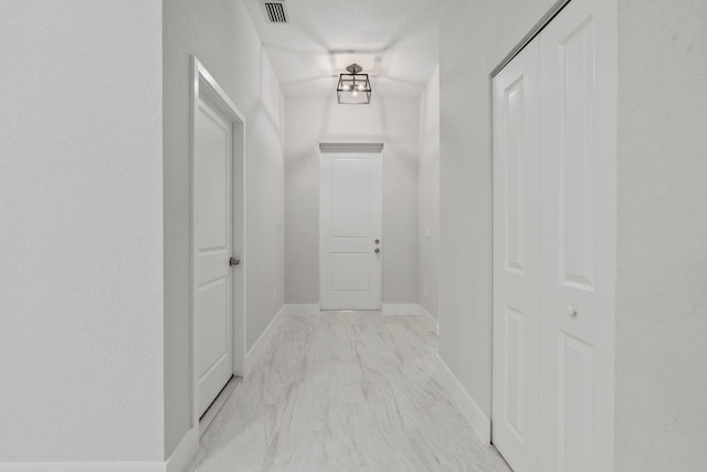 899 Gladiola Ave, Sebastian, FL 32958 - corridor featuring baseboards, visible vents, and marble finish floor