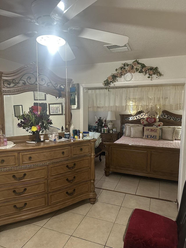 bedroom with light tile patterned floors and visible vents