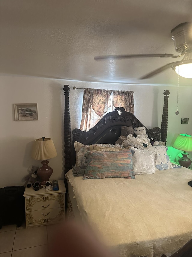 tiled bedroom featuring a ceiling fan