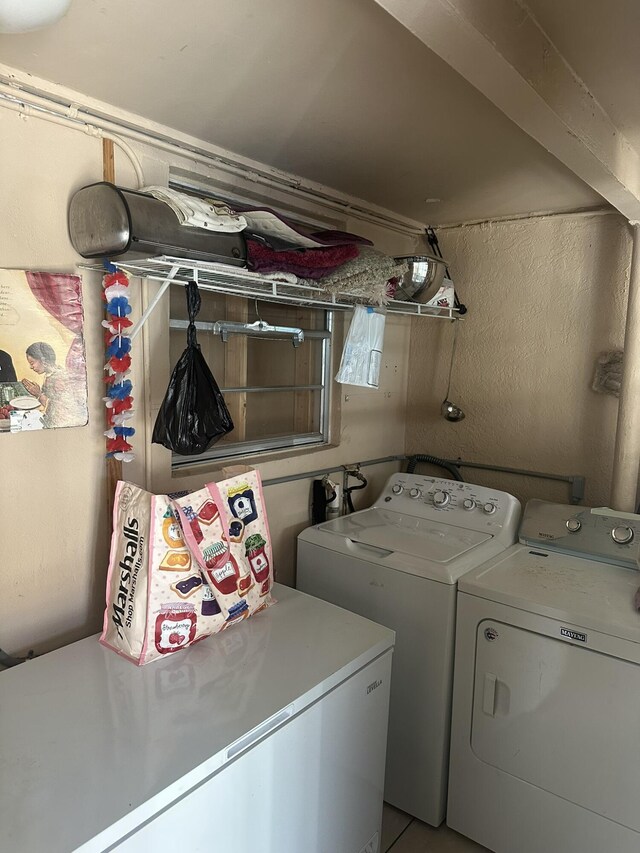washroom featuring washing machine and clothes dryer and laundry area