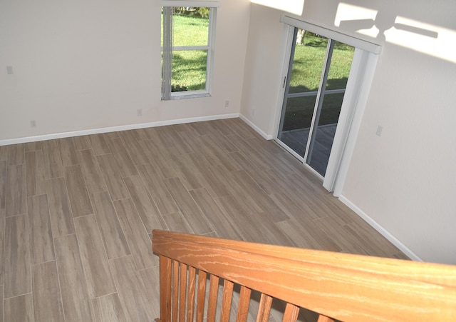 spare room featuring wood finished floors and baseboards