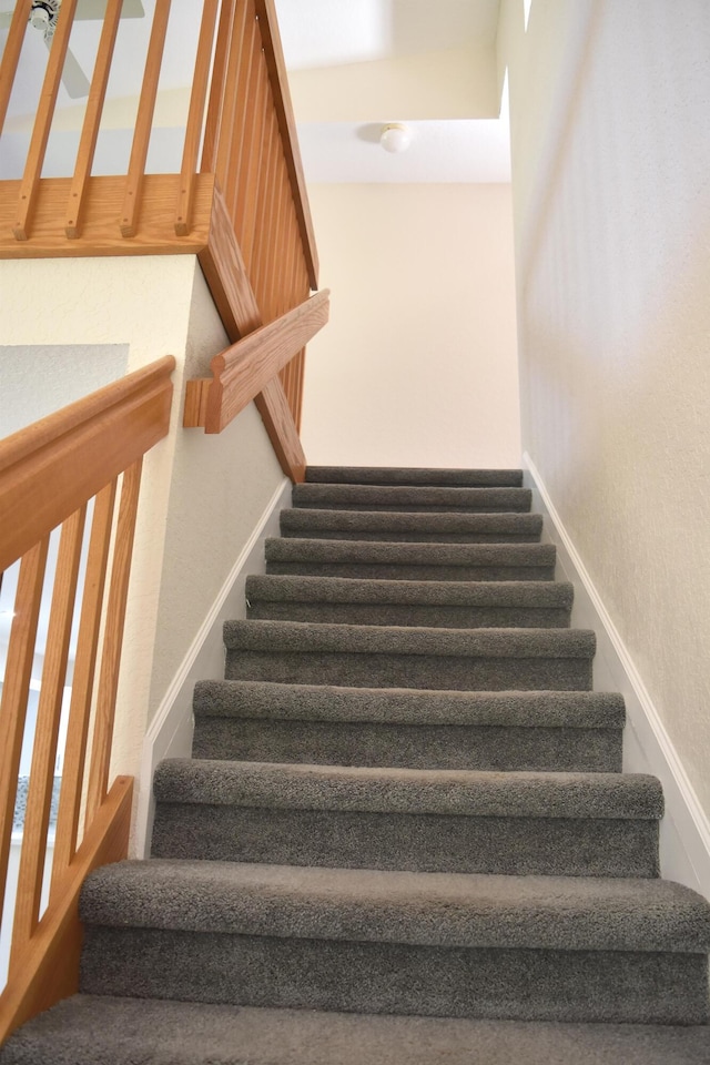 stairs featuring baseboards