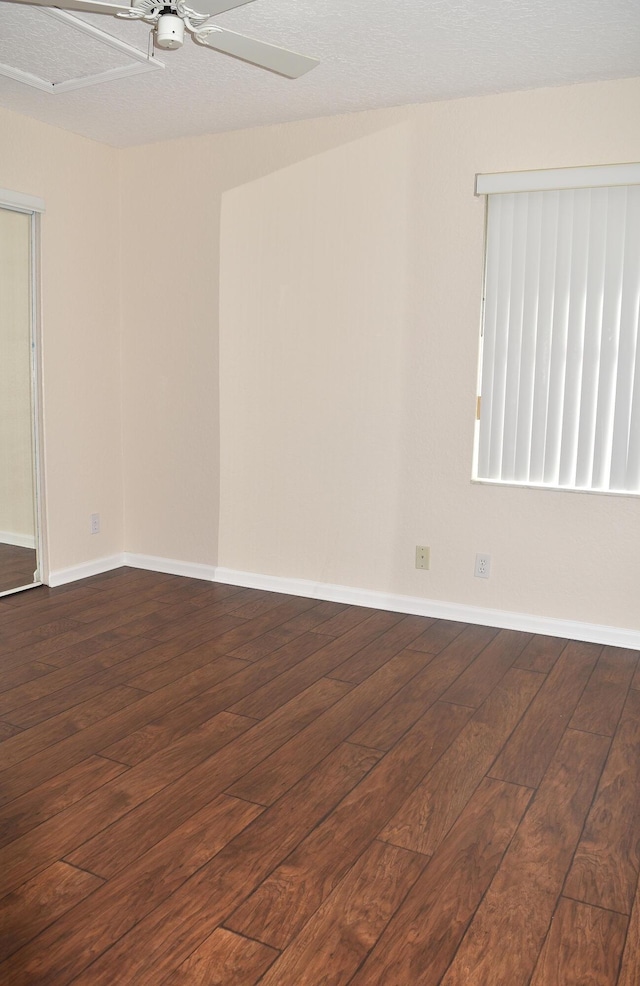 empty room with ceiling fan, baseboards, and wood-type flooring