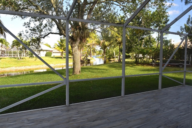 unfurnished sunroom featuring a water view
