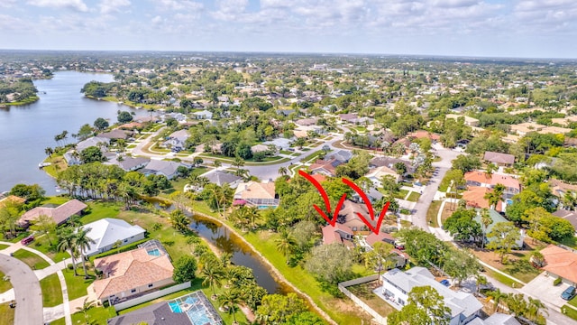 bird's eye view with a residential view and a water view