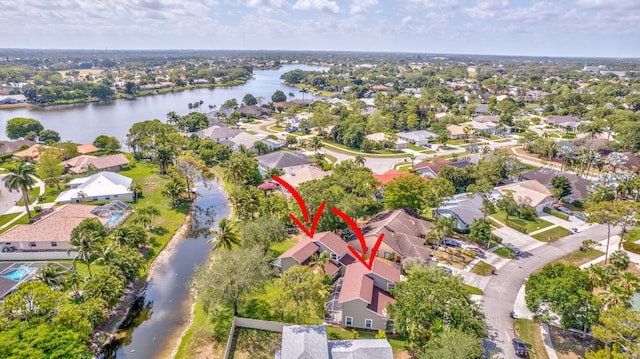 drone / aerial view featuring a residential view and a water view