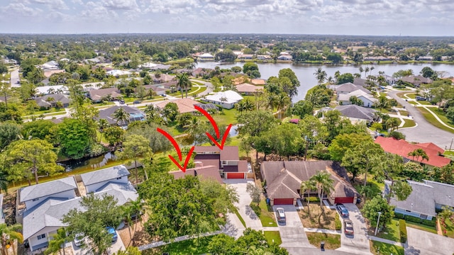 bird's eye view with a residential view and a water view