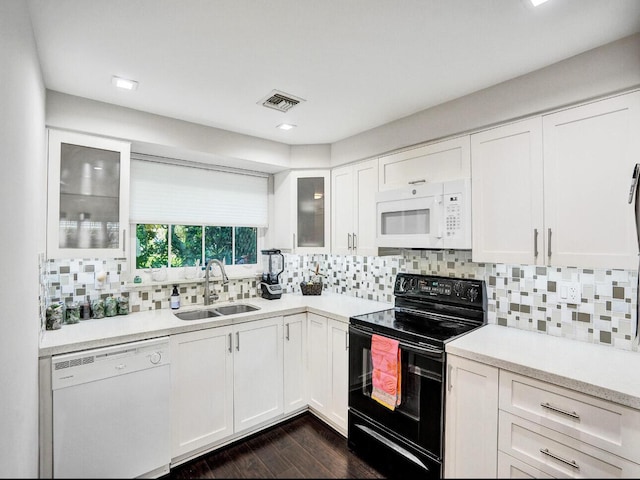 kitchen featuring a sink, white cabinets, white appliances, and light countertops