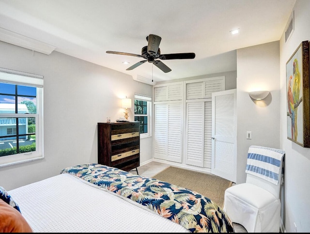 bedroom with recessed lighting, ceiling fan, visible vents, and a closet