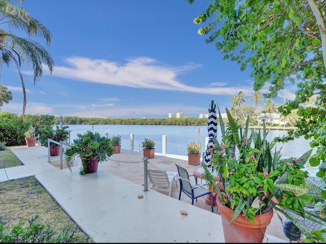 view of home's community with a water view and a patio area