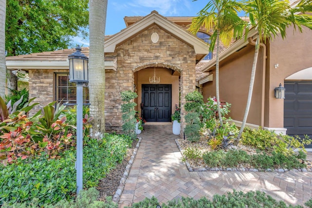 doorway to property with stucco siding and stone siding