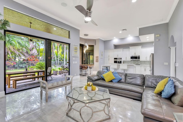 living area featuring crown molding, visible vents, baseboards, a ceiling fan, and marble finish floor