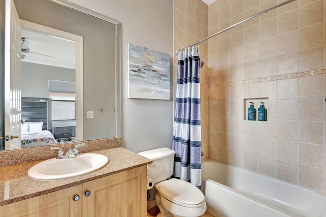 ensuite bathroom featuring shower / bathtub combination with curtain, vanity, toilet, ornamental molding, and ensuite bathroom