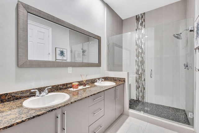 full bath with a sink and a shower stall