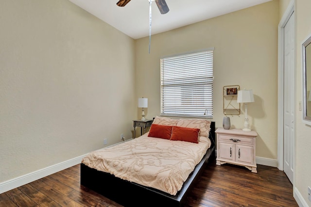 bedroom with ceiling fan, baseboards, and dark wood-type flooring