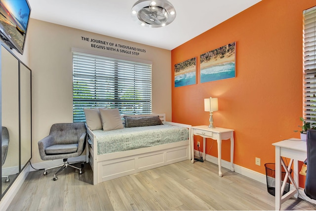 bedroom with baseboards and wood finished floors