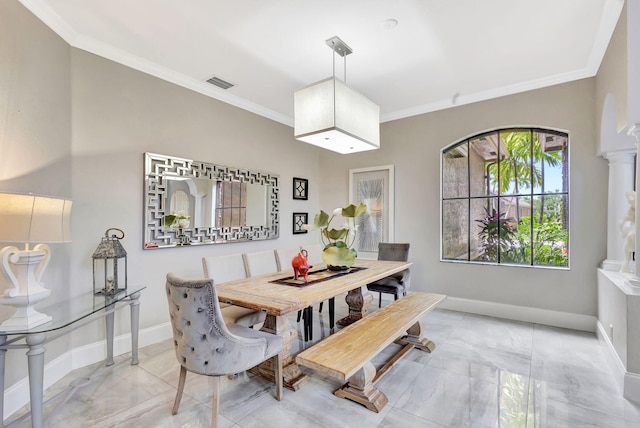 dining room featuring crown molding, marble finish floor, and baseboards