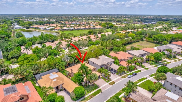drone / aerial view with a water view and a residential view