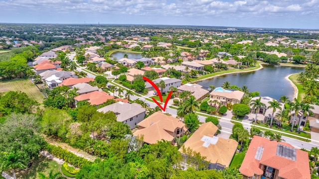 drone / aerial view featuring a residential view and a water view