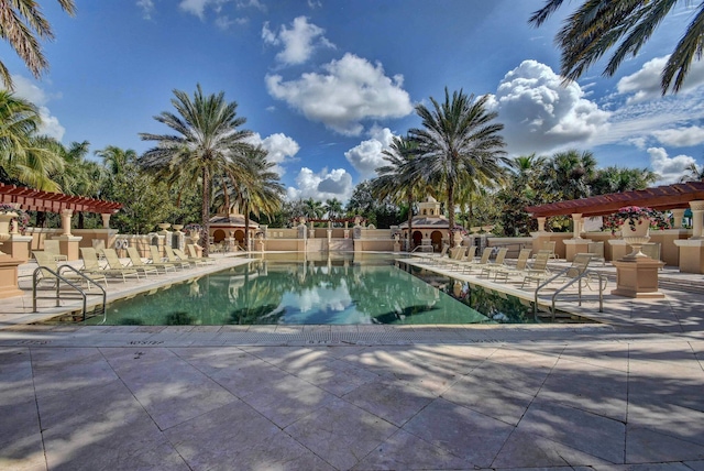 pool featuring exterior fireplace, a pergola, and a patio area