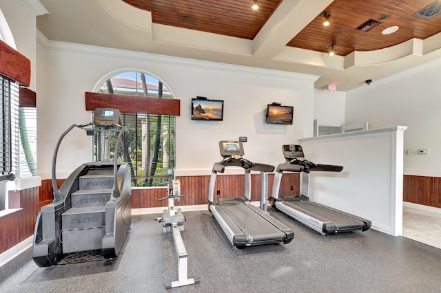 workout area with visible vents, baseboards, wooden ceiling, wooden walls, and wainscoting