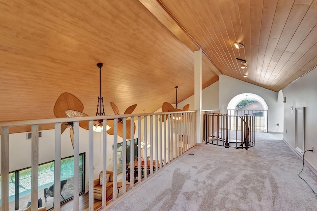 hall with wooden ceiling, beamed ceiling, carpet floors, and high vaulted ceiling