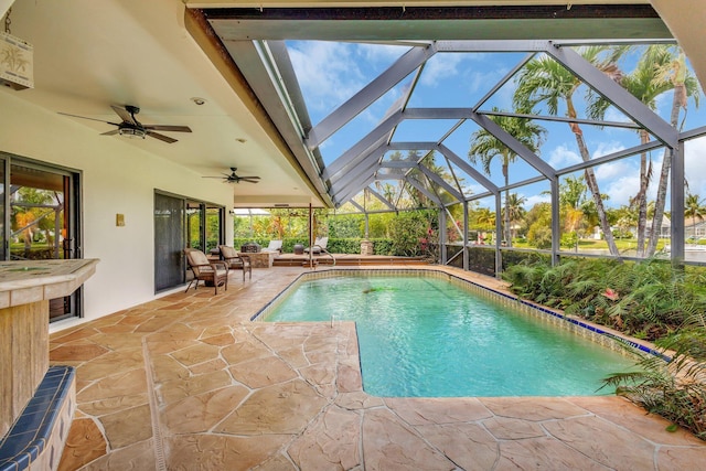 pool with a lanai, a ceiling fan, and a patio area